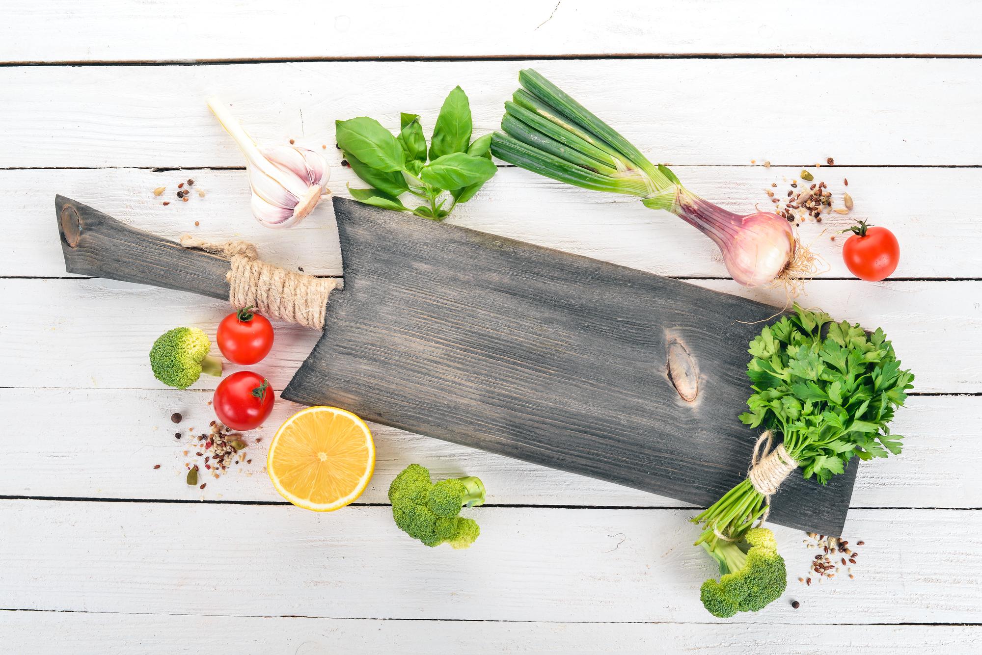 Fresh ingredients on wooden board with herbs